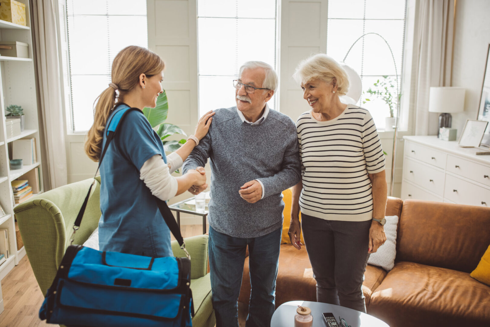 Healthcare worker visiting elderly couple at home. Healthcare worker visiting elderly couple at home.