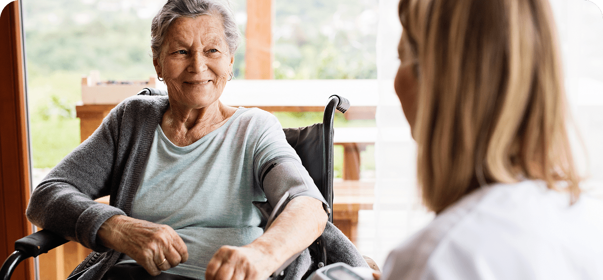 Elderly woman smiling at caregiver. Elderly woman smiling at caregiver.
