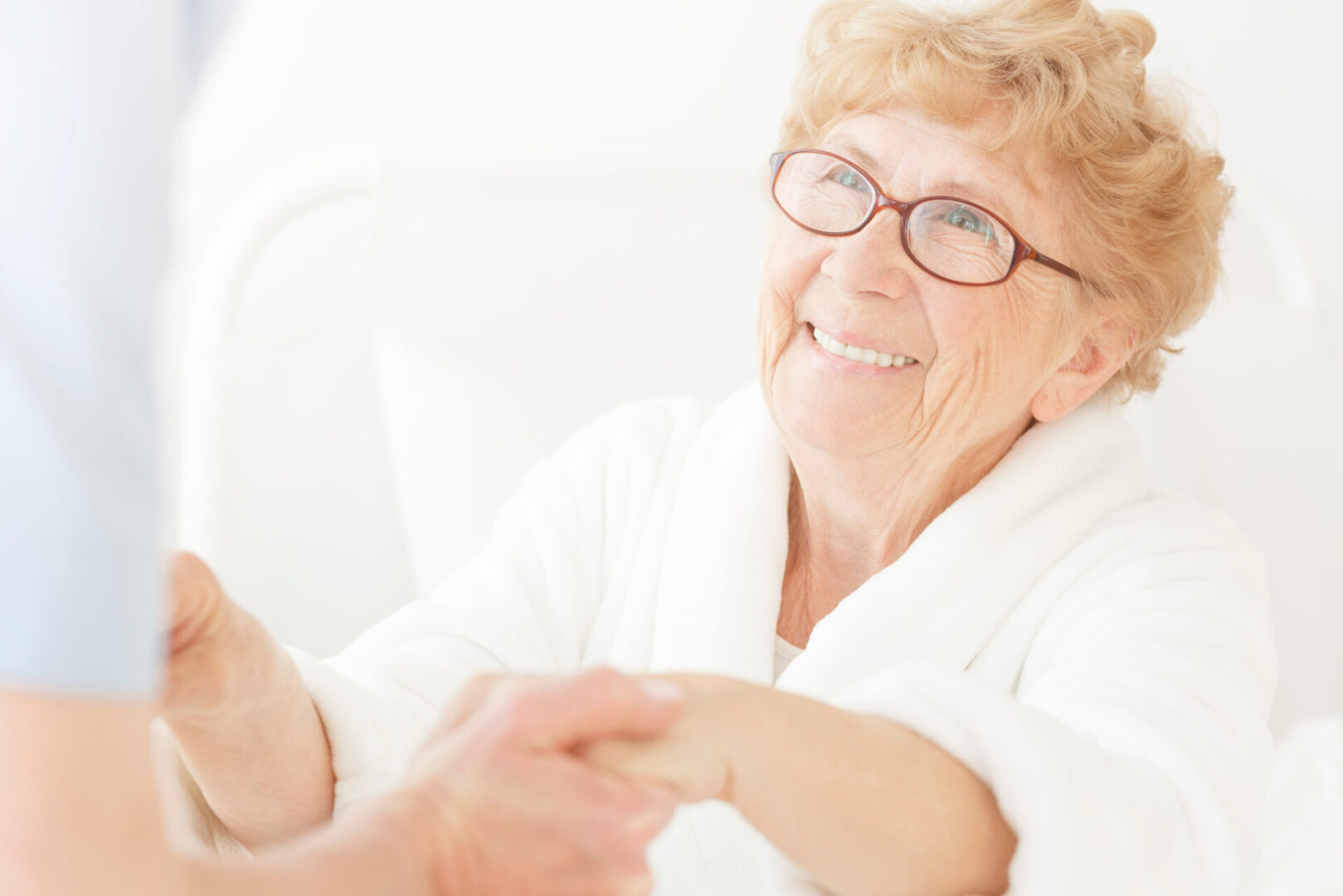 Elderly woman smiling and holding hands. Elderly woman smiling and holding hands.