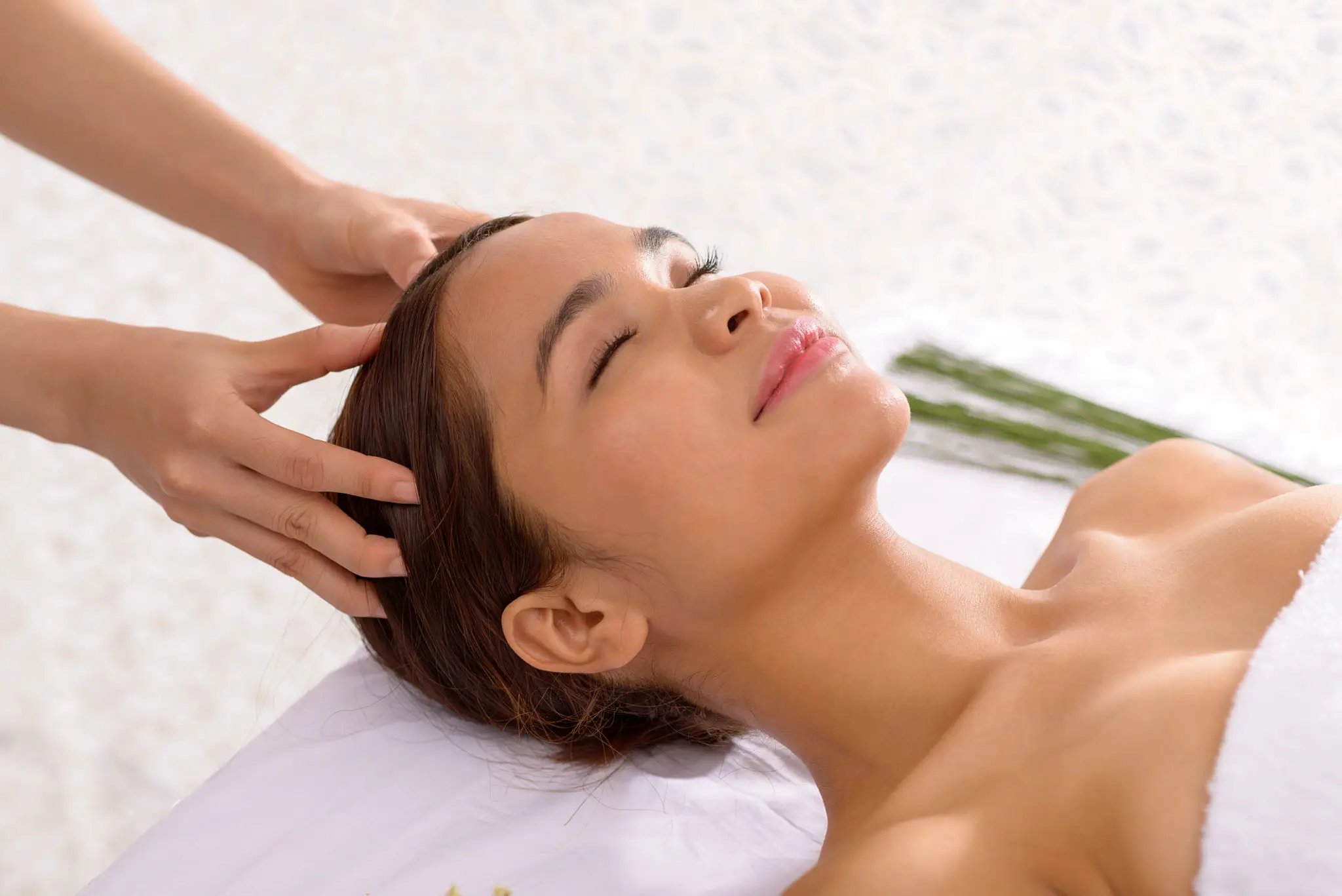Woman receiving a relaxing head massage.