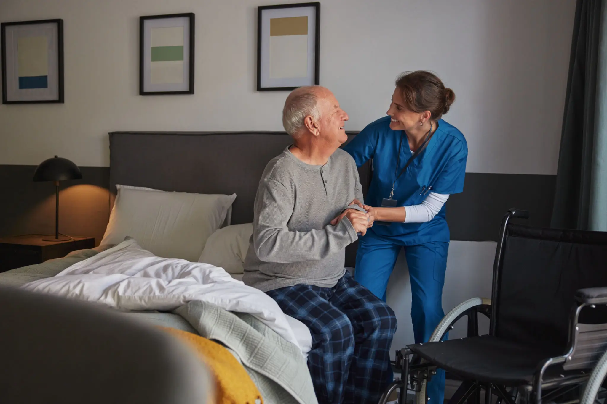 Elderly man assisted by smiling healthcare worker.