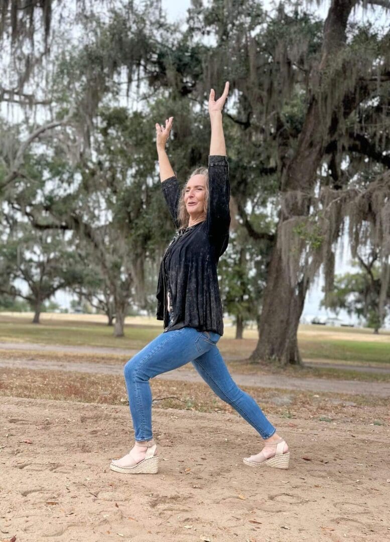 Woman posing enthusiastically in a park.