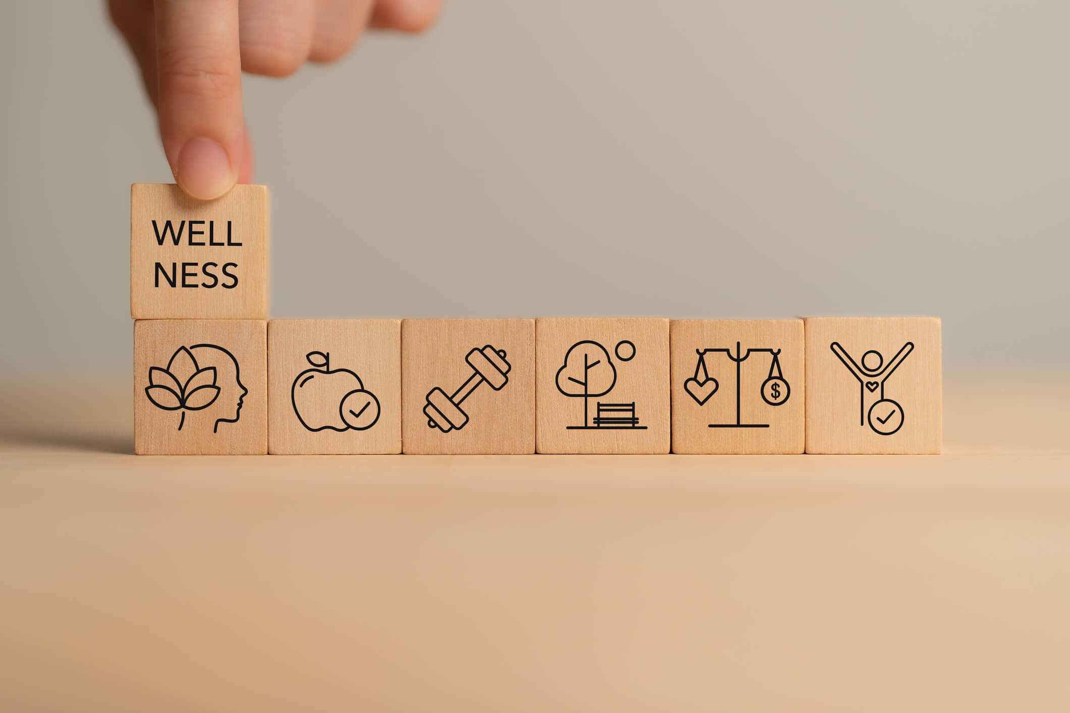 Wooden blocks with wellness icons and text.