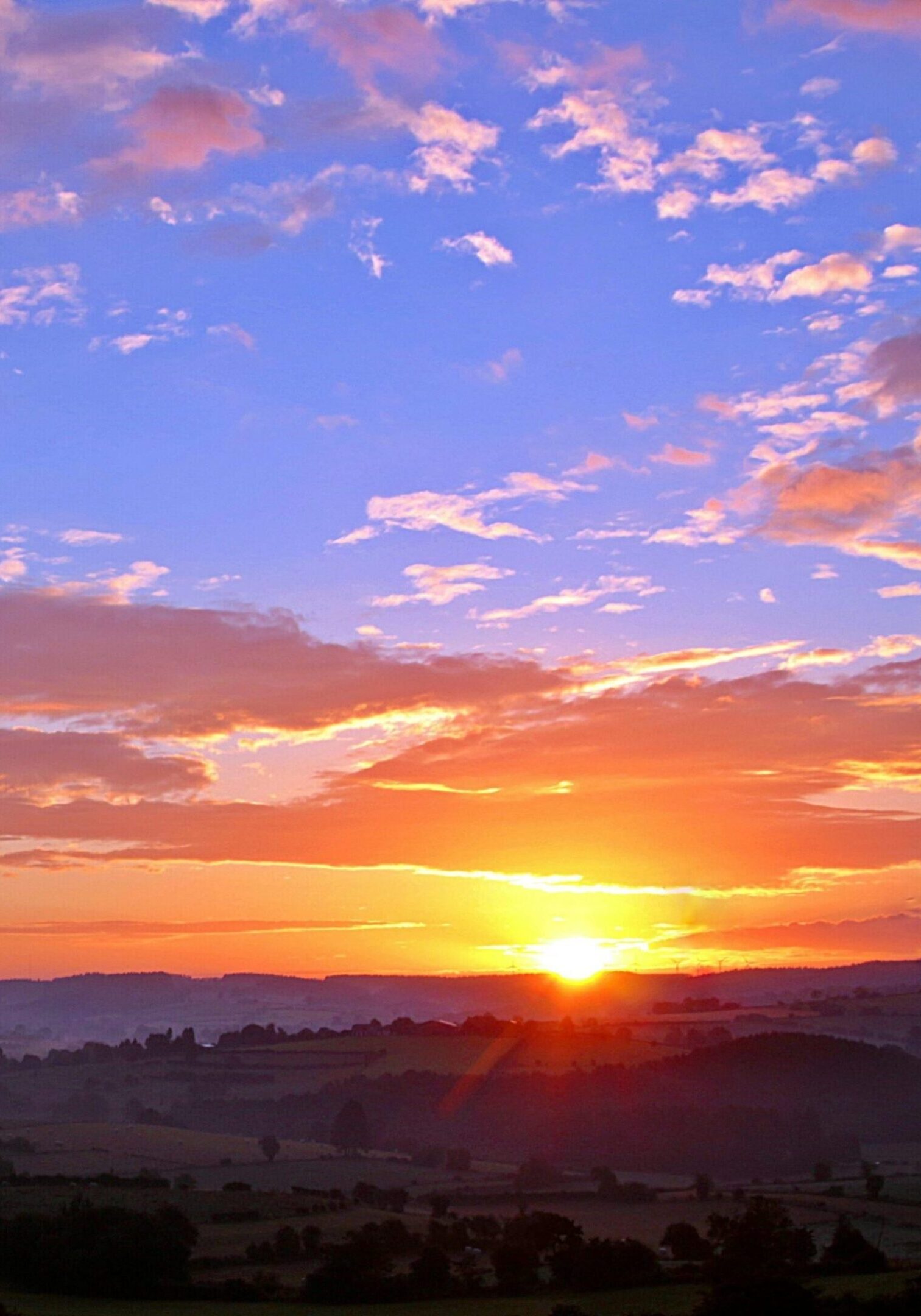 Vibrant sunset over a rural landscape.